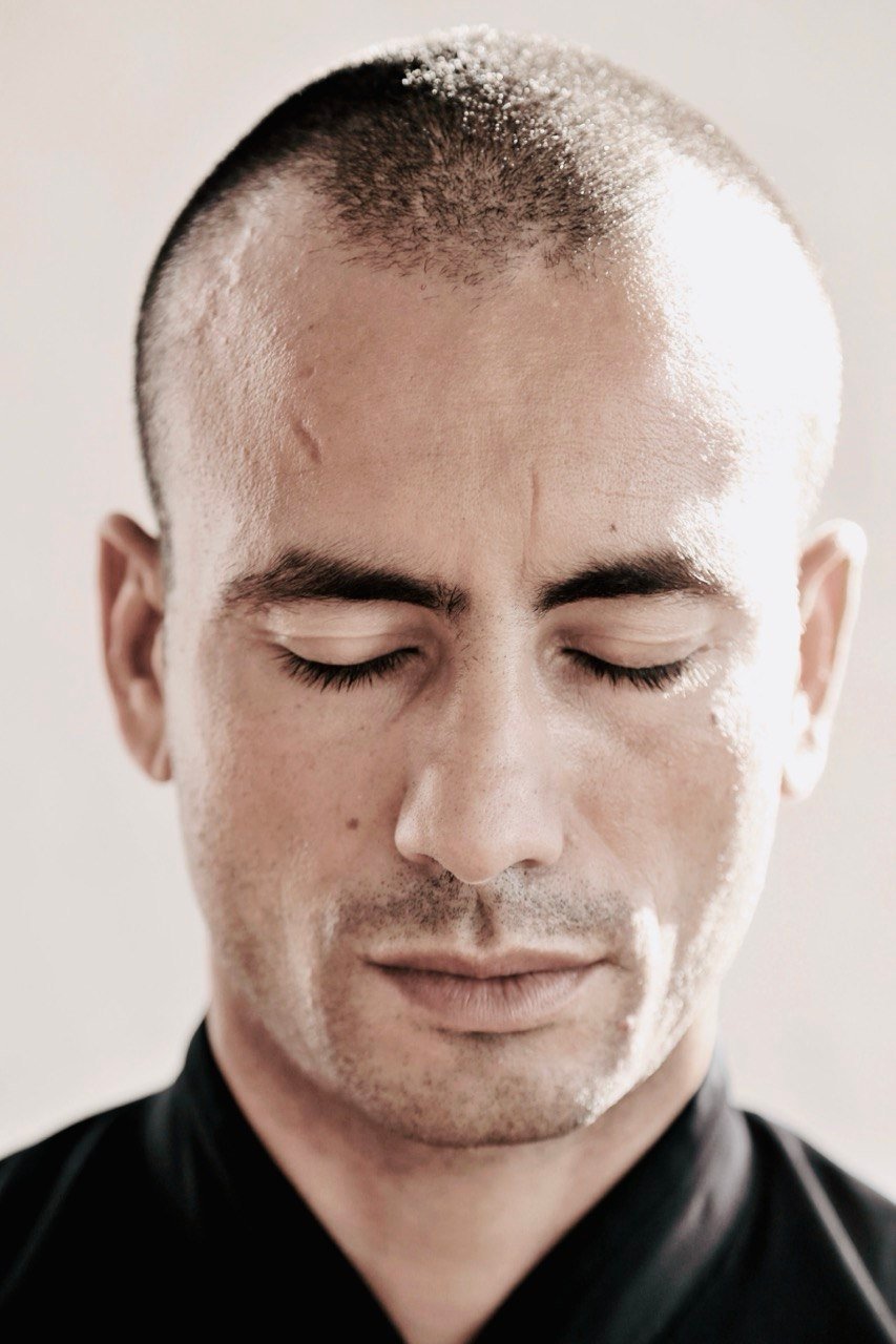 John Sammut in deep meditation тАФ eyes closed, still presence
